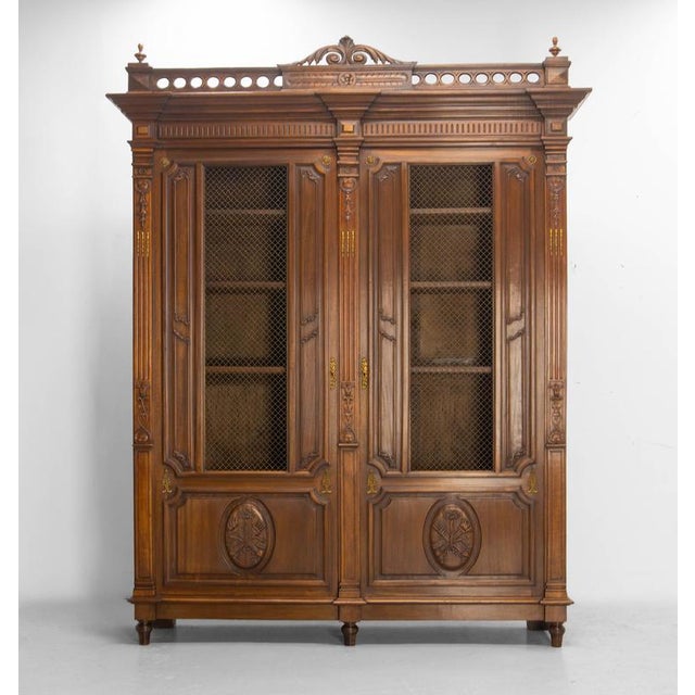 Large French bookcase in carved exotic wood, Louis XVI style, circa 1890 An imposing French bookcase crafted circa 1890 in...