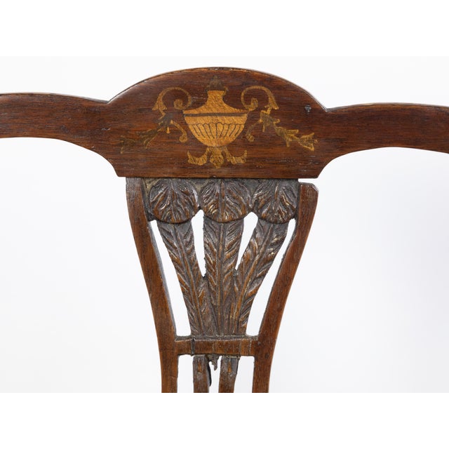 An English mahogany child's chair from the 19th century, with feather motifs and marquetry décor. Created in England...