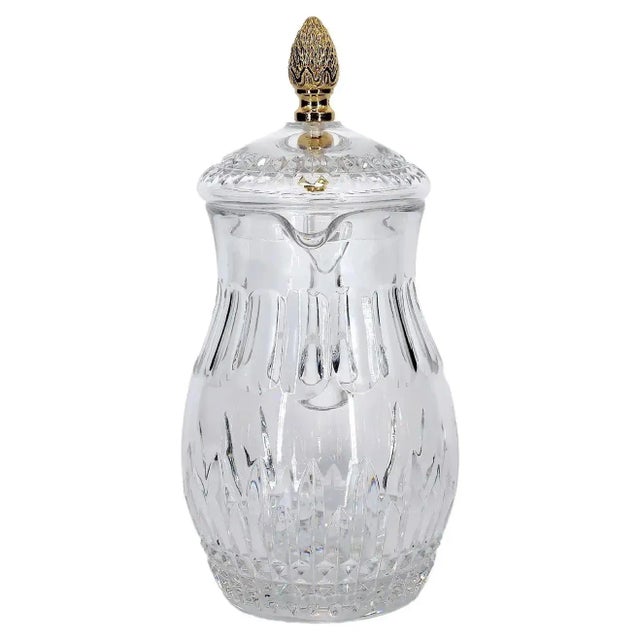 Late 20th century cut crystal tableware / barware covered serving pitcher. The piece features a gilt top brass pinecone...