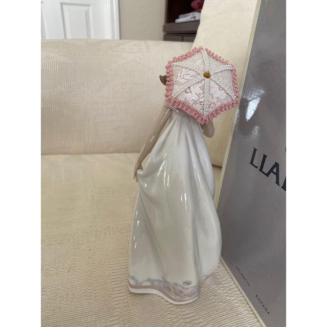 The figurine is in excellent pre-owned condition. No chips, cracks or repairs. The delicate porcelain parasol, lace border...