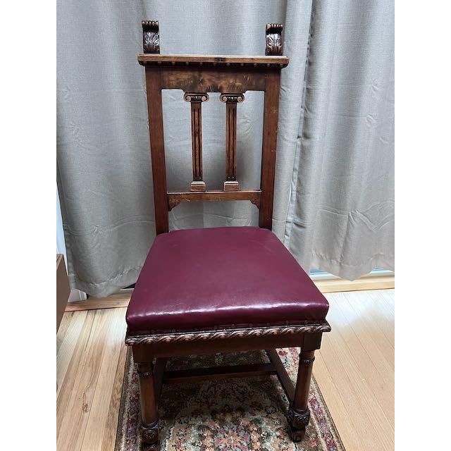 Solid wood dining chairs, beautifully detailed. Seats are upholstered in deep burgundy leather accented with original...