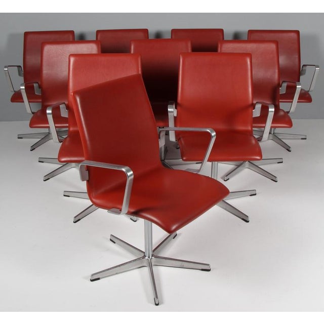 Arne Jacobsen Oxford armchair with five star base in chrome. Original red brown leather upholstery. Made by Fritz Hansen....