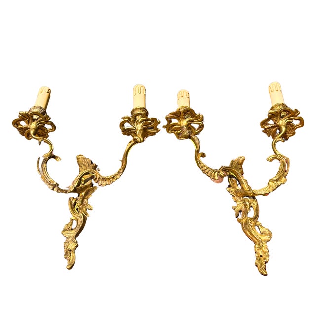 A wonderfully theatrical pair of large rococo revival wall sconces in gilt bronze, originally conceived as candle sconces...