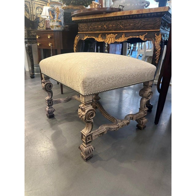 This handsome Italian Baroque-style bench features a generously upholstered rectangular seat covered in a neutral cream...