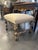 This handsome Italian Baroque-style bench features a generously upholstered rectangular seat covered in a neutral cream...