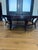A sophisticated round coffee table crafted by the renowned Hickory Chair Furniture Company, showcasing a richly figured...