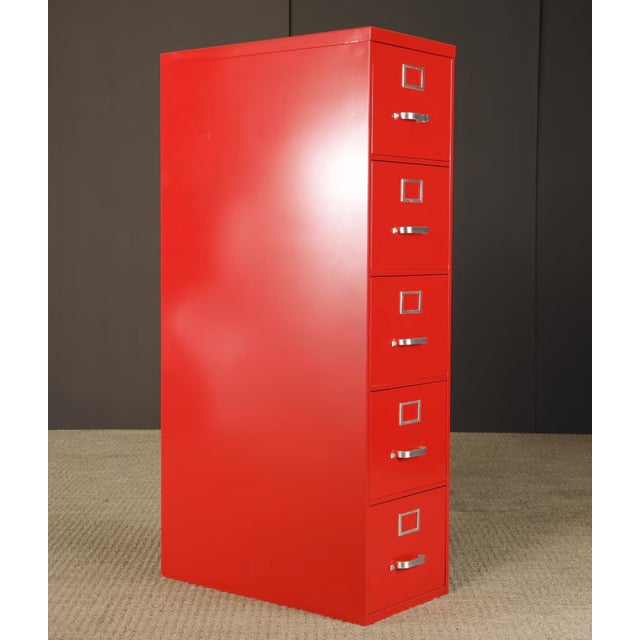 Striking vintage five-drawer steel filing cabinet finished in a bold red powder-coated finish. This mid-century industrial...
