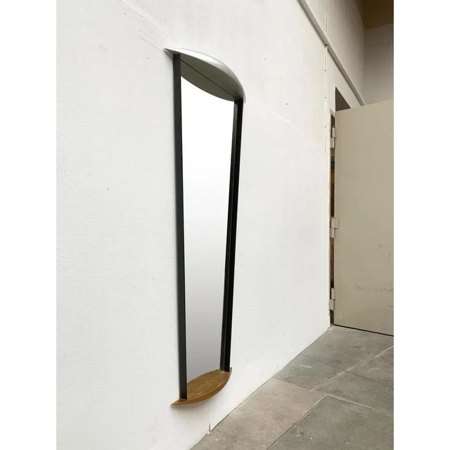 Imposing mirror in postmodern design language. A mirror of imposing size and heavy quality. A metal plate serves as a...