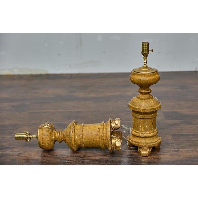 A pair of French Baroque Revival 19th century giltwood fragments made into modern table lamps wired for the USA. Infuse a...