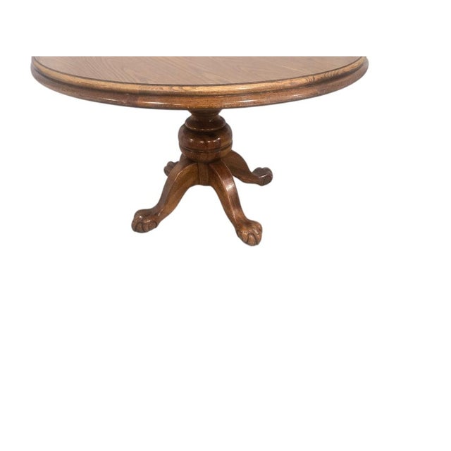 This vintage round oak dining table brings timeless character and versatility to any dining space. Measuring 47 inches in...