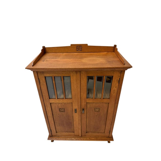 Stunning and elegant Arts & Crafts Art Nouveau bookcase. Striking Dutch design from the 1900s. Solid oak base with...