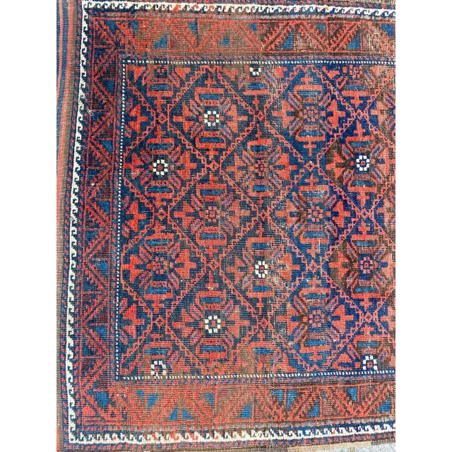 Nice antique Baluch rug with geometrical tribal design and beautiful natural colors, entirely hand knotted with wool...