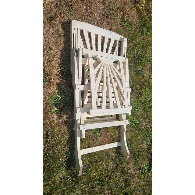 A rare and highly decorative British Art Deco folding garden lounger, distinguished by its striking sunray design and...