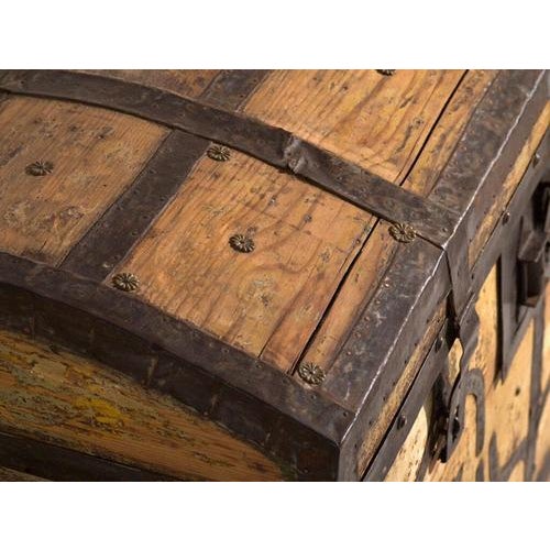 This antique iron-bound chest in pine wood is a Central European dome-topped chest with riveted wrought-iron strapwork and...