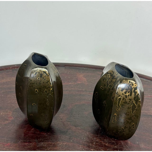 A superb and rare pair of small Art Deco metal vases with an architectural design and remarkable surface finish. Details &...