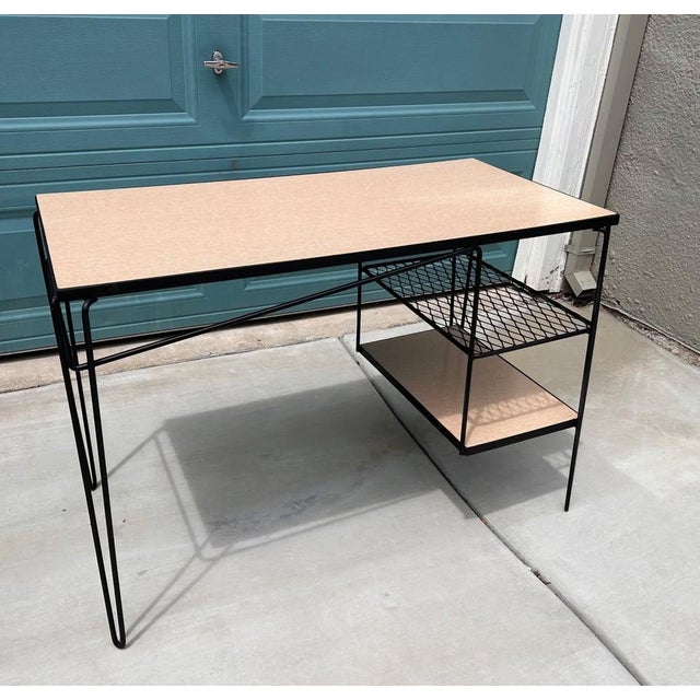 This is a vintage mid-century modern atomic-age student desk featuring a light-colored laminate (Formica/melamine) top,...