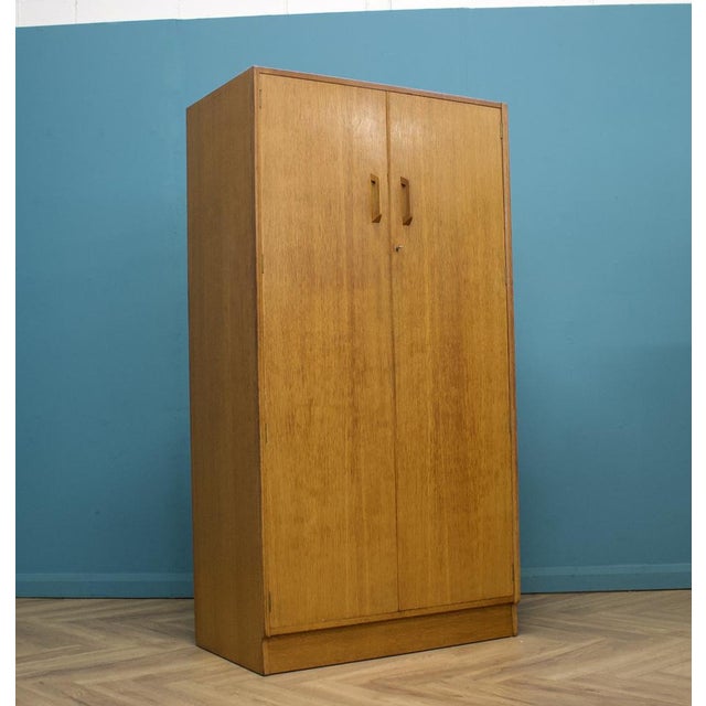 A freestanding oak wardrobe from G Plan from the Brandon range - circa 1950s Featuring a hanging rail This piece has an...