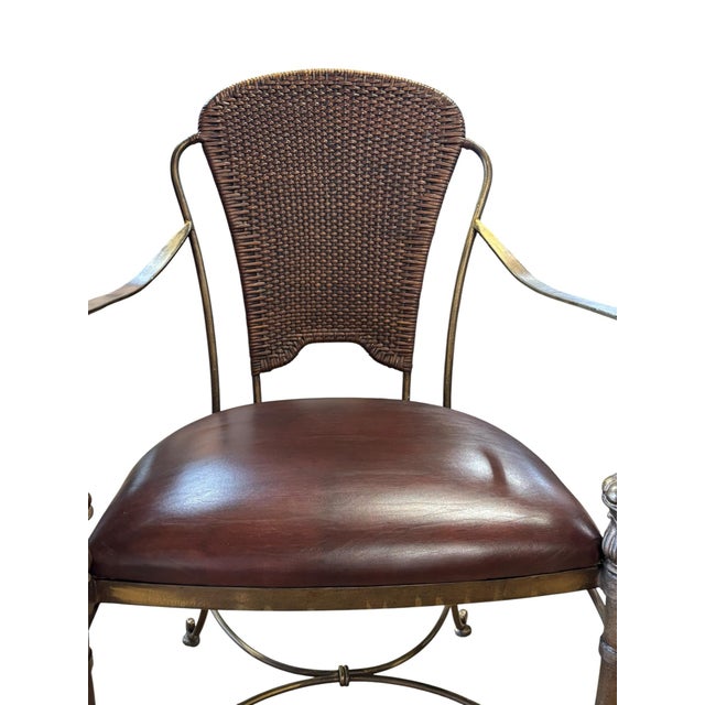 Elegant Maitland-Smith armchair featuring a patinated metal frame with faux bamboo legs, scrolling arms, woven cane back,...