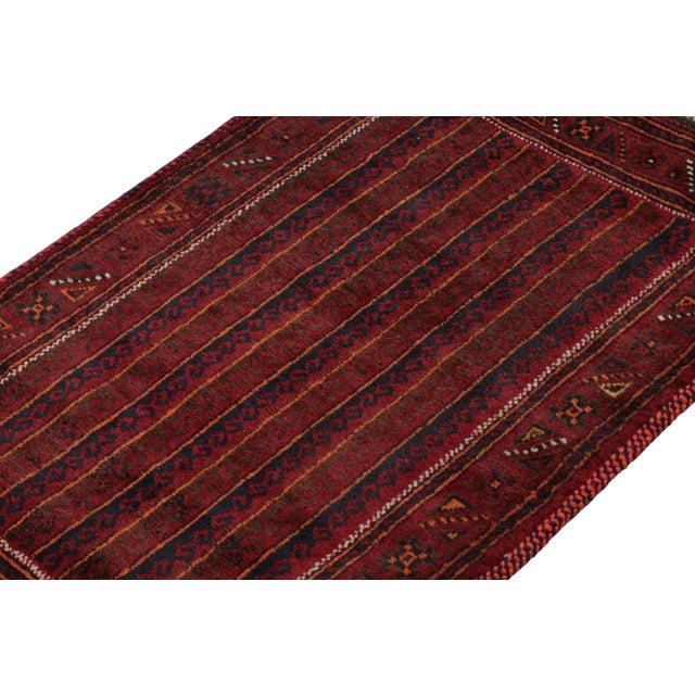 Hand knotted in wool, this 2x4 Baluch scatter rug represents a new line of tribal carpets in the Modern Classics...