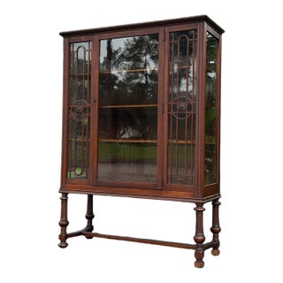 Antique 1930s Mahogany Glass-Front Curio Cabinet With Geometric Detailing & Turned Legs For Sale