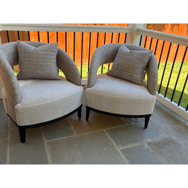 Adriana Hoyos Bolero 300 armchairs. Set of two. Features upholstered seat and backrest. Includes matching throw pillows....