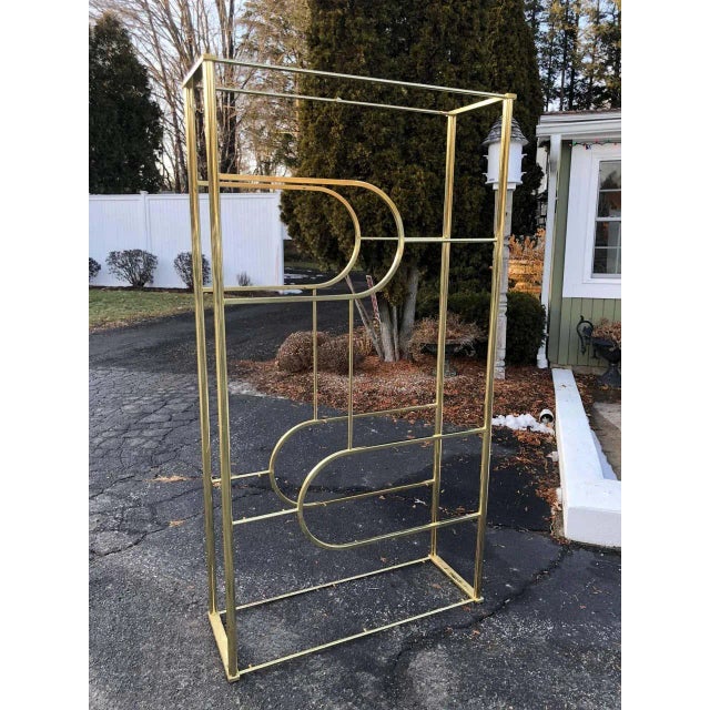Design Institute of America brass etagere. Elegant Hollywood Regency style piece. There are eight glass shelves of various...