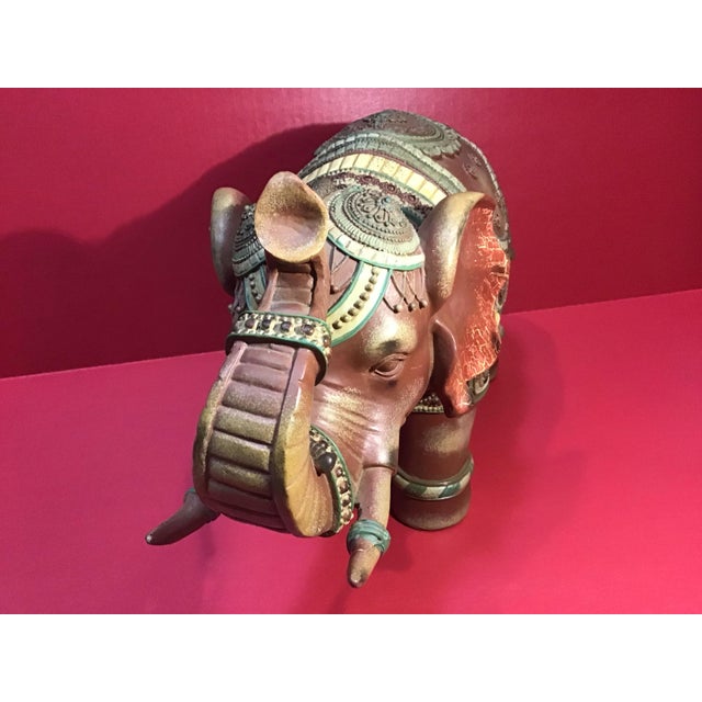 Beautiful large decorative elephant sculpture featuring intricate embossed patterns, hand‑painted detailing, and a raised...