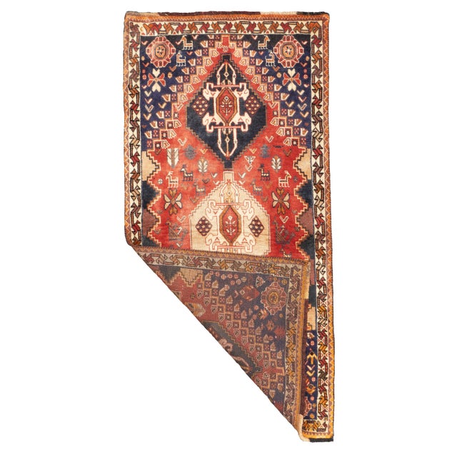 Hand-knotted Persian Qashqai rug, circa 1970. The rug has three diamond-shaped medallions aligned vertically within a...