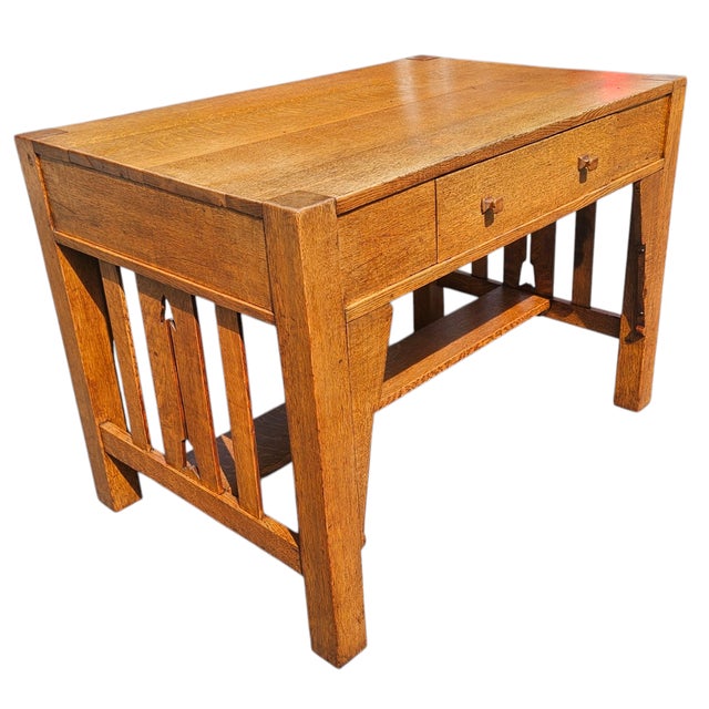 This Antique Arts and Crafts Mission Oak Library Table with Arrow Accents is a distinguished example of early 20th-century...