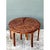 This vintage coffee table showcases an intricately inlaid wood top, divided into three mirrored sections that together...