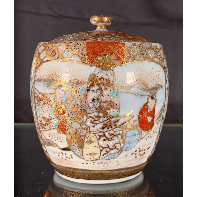 This beautiful lidded jar is painted in the Satsuma manner on a translucent porcelain body rather than the heavy...