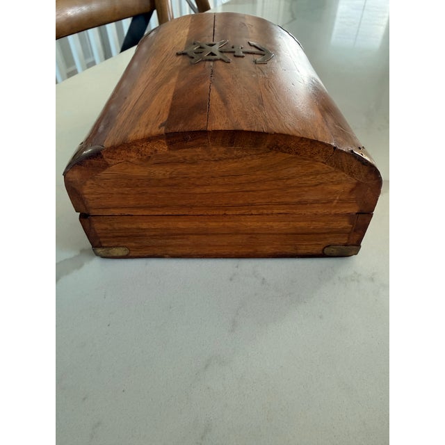 This vintage wooden jewelry box features a beautiful brass ships wheel and anchor inlay on the lid, adding a nautical...