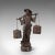 This is a tall antique decorative figure. A Chinese, bronze statue of a water carrier, dating to the late Victorian...
