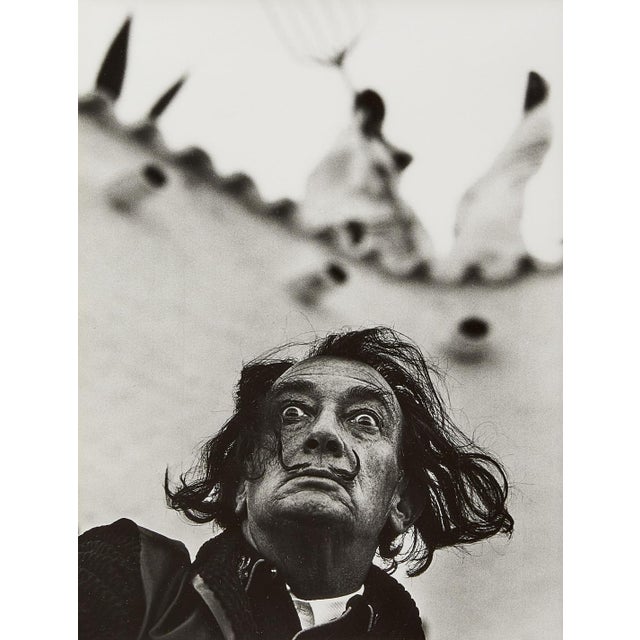 Step into the surreal world of Salvador Dalí with Philippe Halsman’s iconic 1964 portrait in Port Lligat. This masterful...