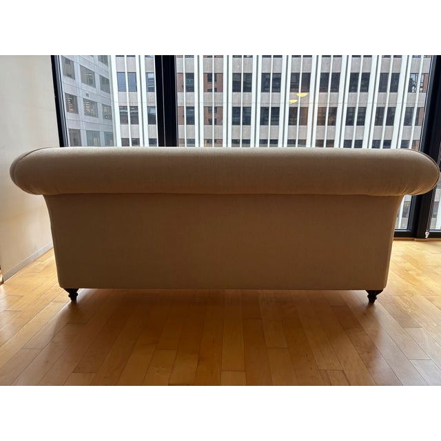 Classic hand carved sofa with walnut frame and upholstered in a neutral fabric. By designer Adriana Hoyos first...