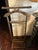 Classic vintage wooden valet stand featuring a sculpted jacket hanger, integrated trouser bar, and sturdy freestanding...