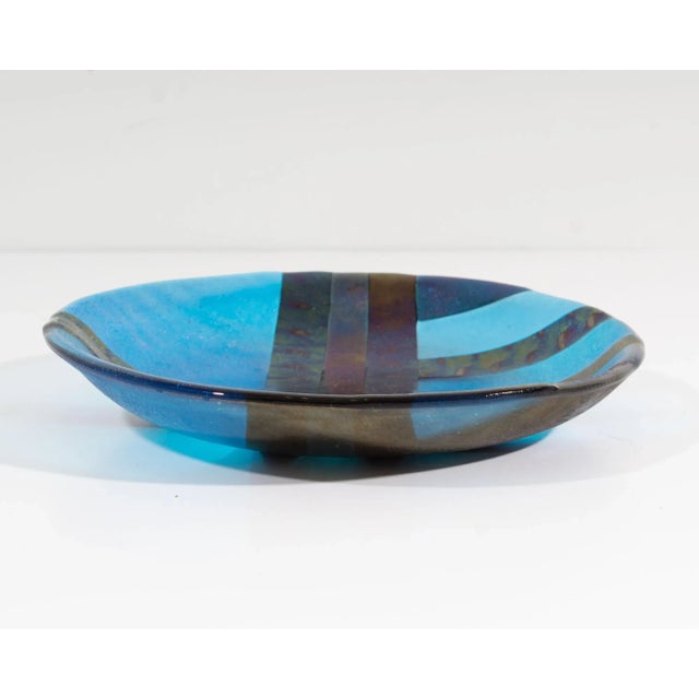 An art glass bowl by the American glass artist Christine McEwan of Verre Visage Studio. This fused glass bowl has a...