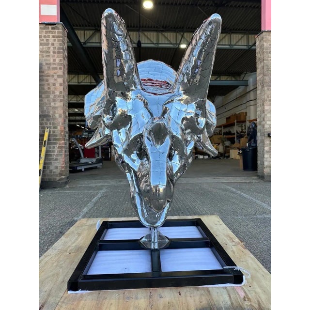 This striking stainless steel Triceratops sculpture is a stunning representation of prehistoric power and elegance....