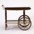 This mid-20th century bar cart is crafted in rich mahogany and accented with finely detailed brass mounts, combining...