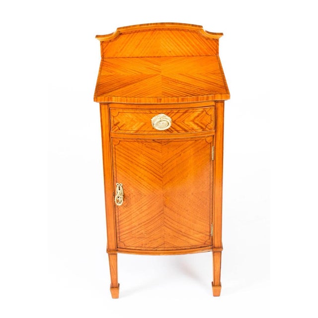 This is a splendid antique Victorian satinwood bedside cabinet, circa 1880 in date. The cabinet features quarter veneered...