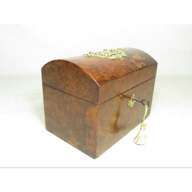 Antique English burr walnut tea caddy, c.1850 It features a domed lid with decorative brass mounts, crafted from highly...
