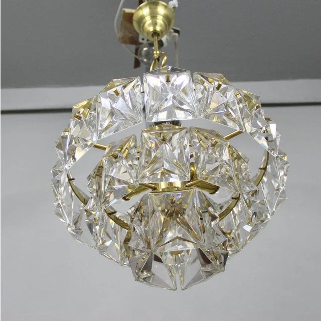 This lamp was produced by the German company Kinkeldey in the 1960s. It has three tiers of glass cascading from a gold...