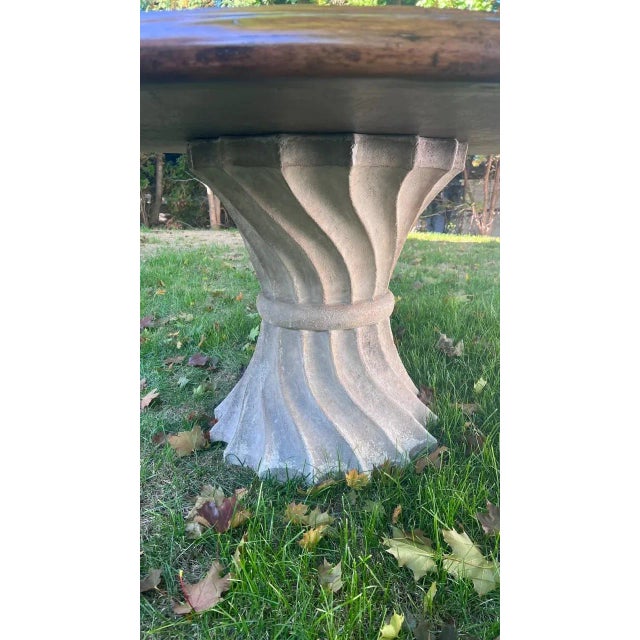 Exceptional round dining table by Artifacts International featuring a substantial 2.5-inch thick wood top paired with a...