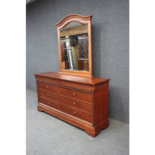 Classic Louis Philippe style dresser by Thomasville from the sought-after Impressions collection, crafted in a warm cherry...