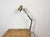Vintage brown adjustable table lamp made in former Czechoslovakia during the 1960s. It features a metal lampshade with...