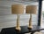 Elegant table lamps crafted circa 1960s in the Mid-Century Modern style, featuring sculptural brass columns composed of...