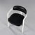 Seat armchair and black -colored faux leather back arranged on white lacquered wood structures forming the armrests and...