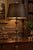 A dramatic vintage Neoclassical table lamp defined by an elongated fluted baluster body, sculptural acanthus-leaf...