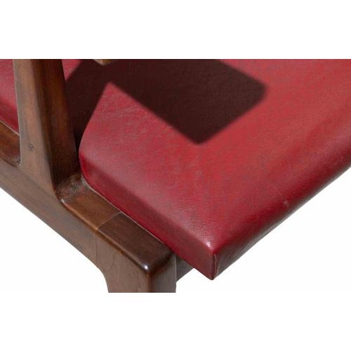 A refined set of three Italian modernist mahogany armchairs designed by Silvio Cavatorta, exemplifying the elegance and...