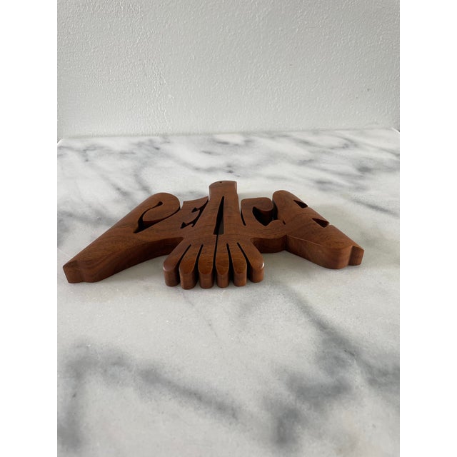 A nicely crafted wall plaque that exudes the peace and love ideals of the hippie era.